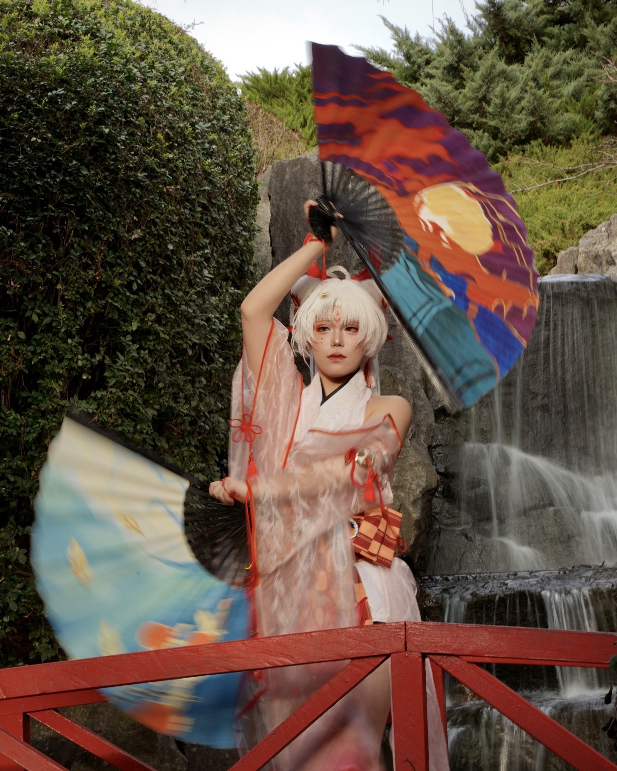 Portrait with intentional fan motion beside a waterfall
