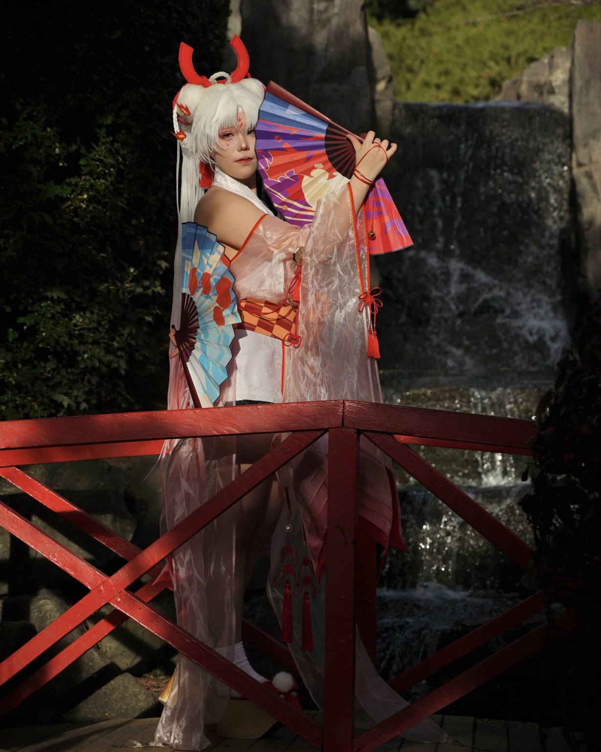 Sunlit creative portrait on a red bridge