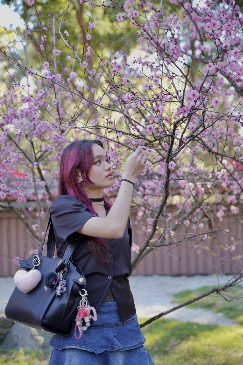 Profile portrait reaching toward a flowering branch