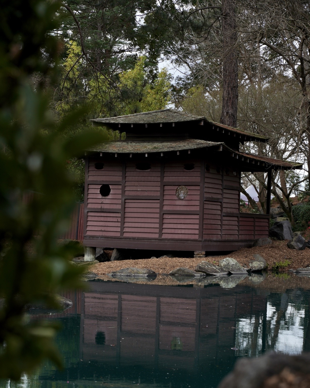 Japanese pavilion reflected in a pond
