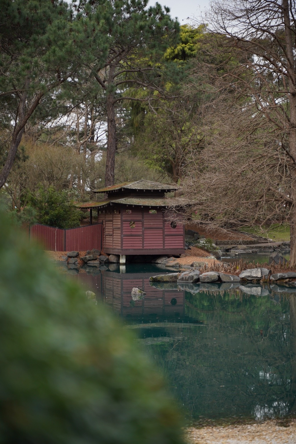 Japanese garden pavilion beside a pond